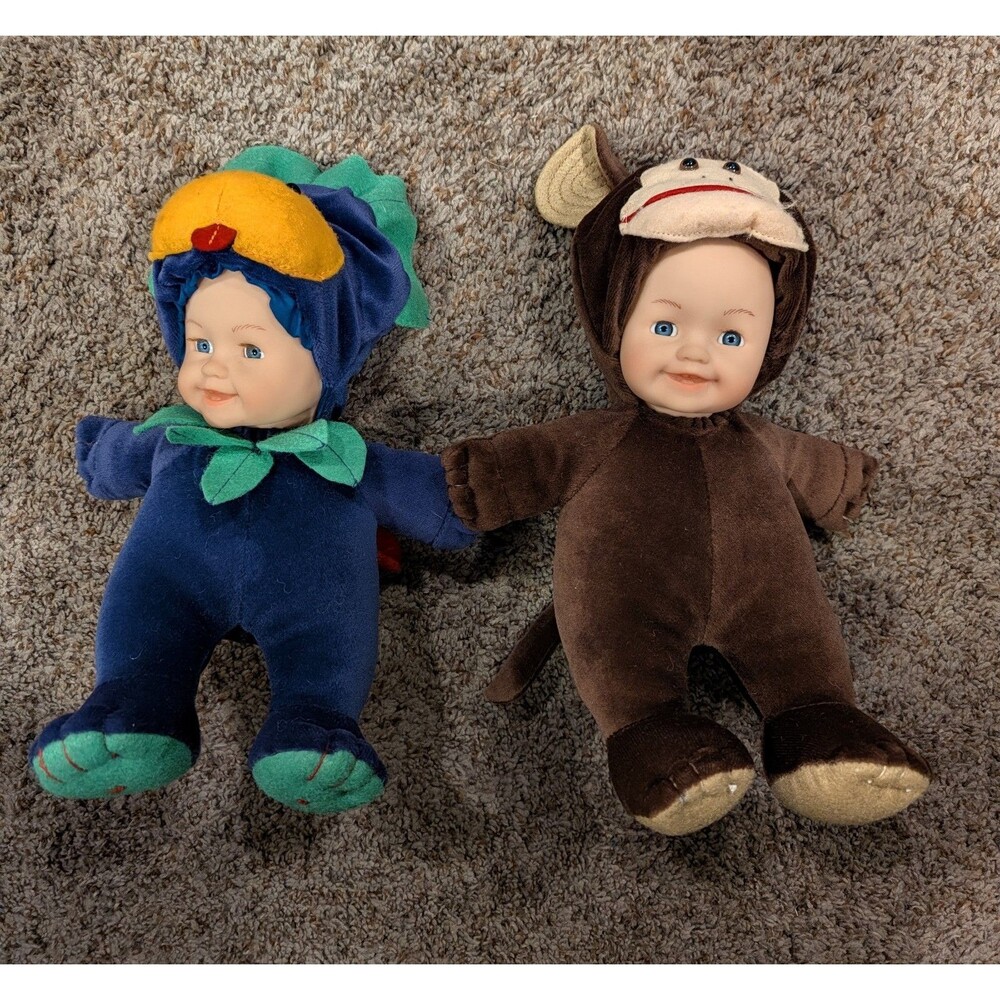 Lot of 2 Anne Geddes Plush Baby Dolls – Blue Triceratops Dinosaur & Sock Monkey
